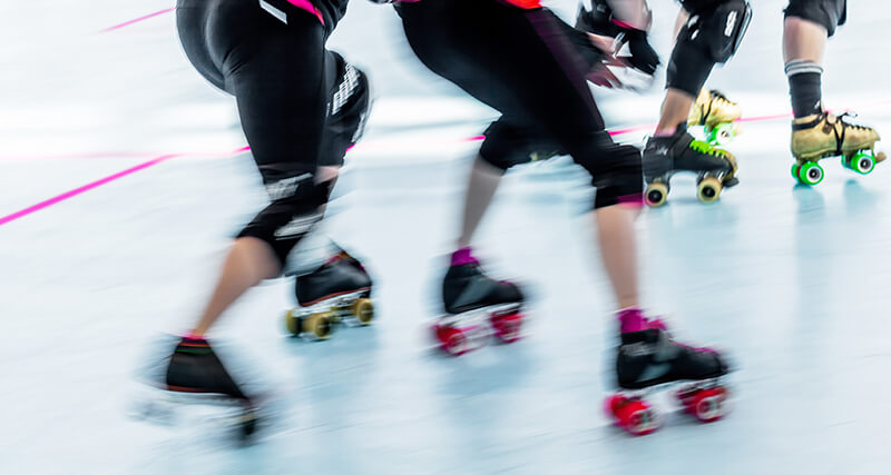 Roller derby team skating