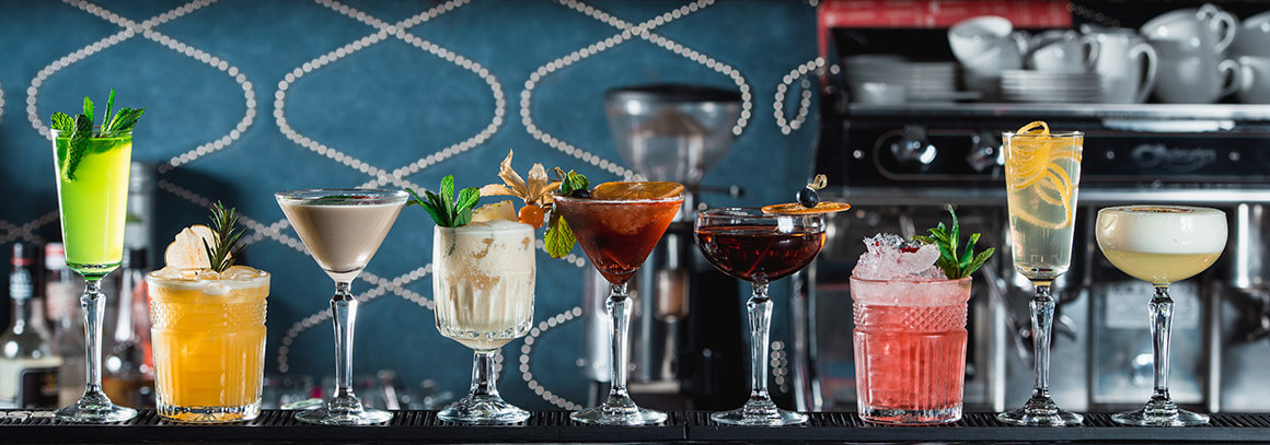 cocktails lined up on bar