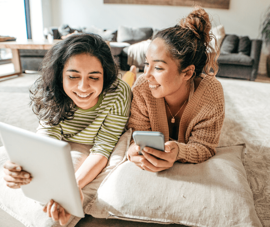 Two female roommates in living room discussing a bill