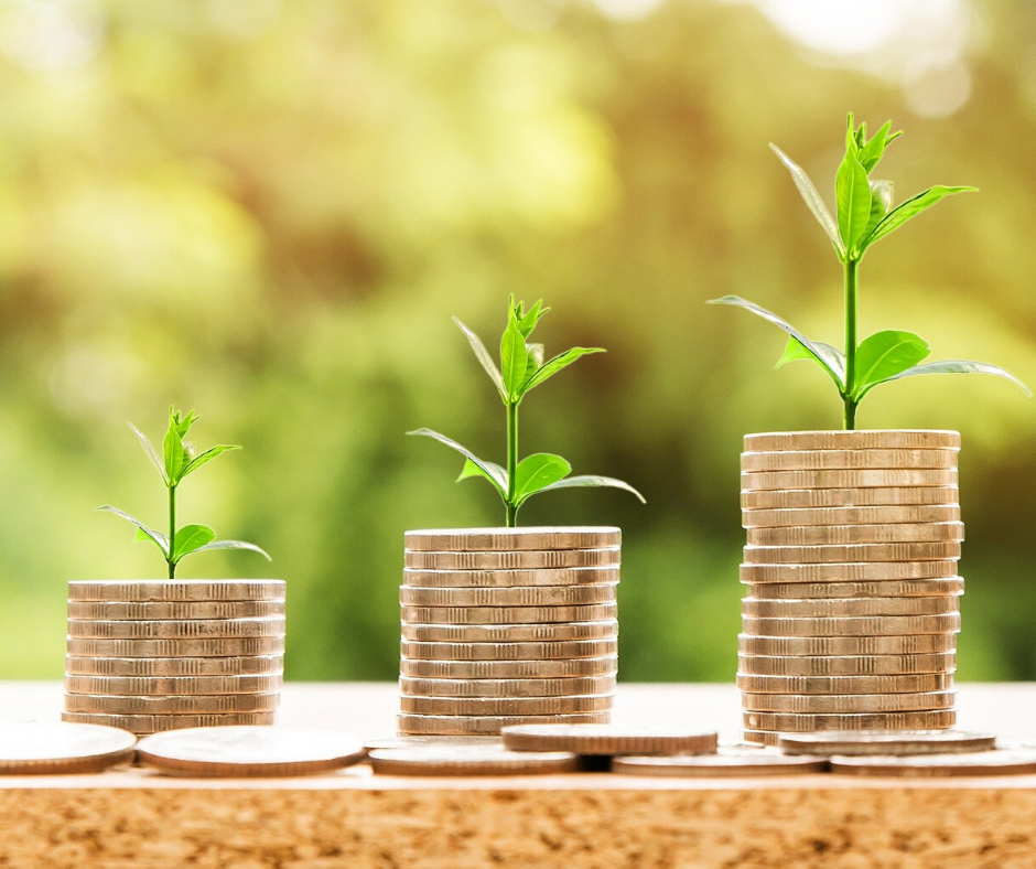 Stacked coins with plants growing from their tops