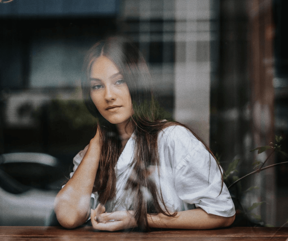 Woman looking out window. Photo credit: Joshua Rawson-Harris