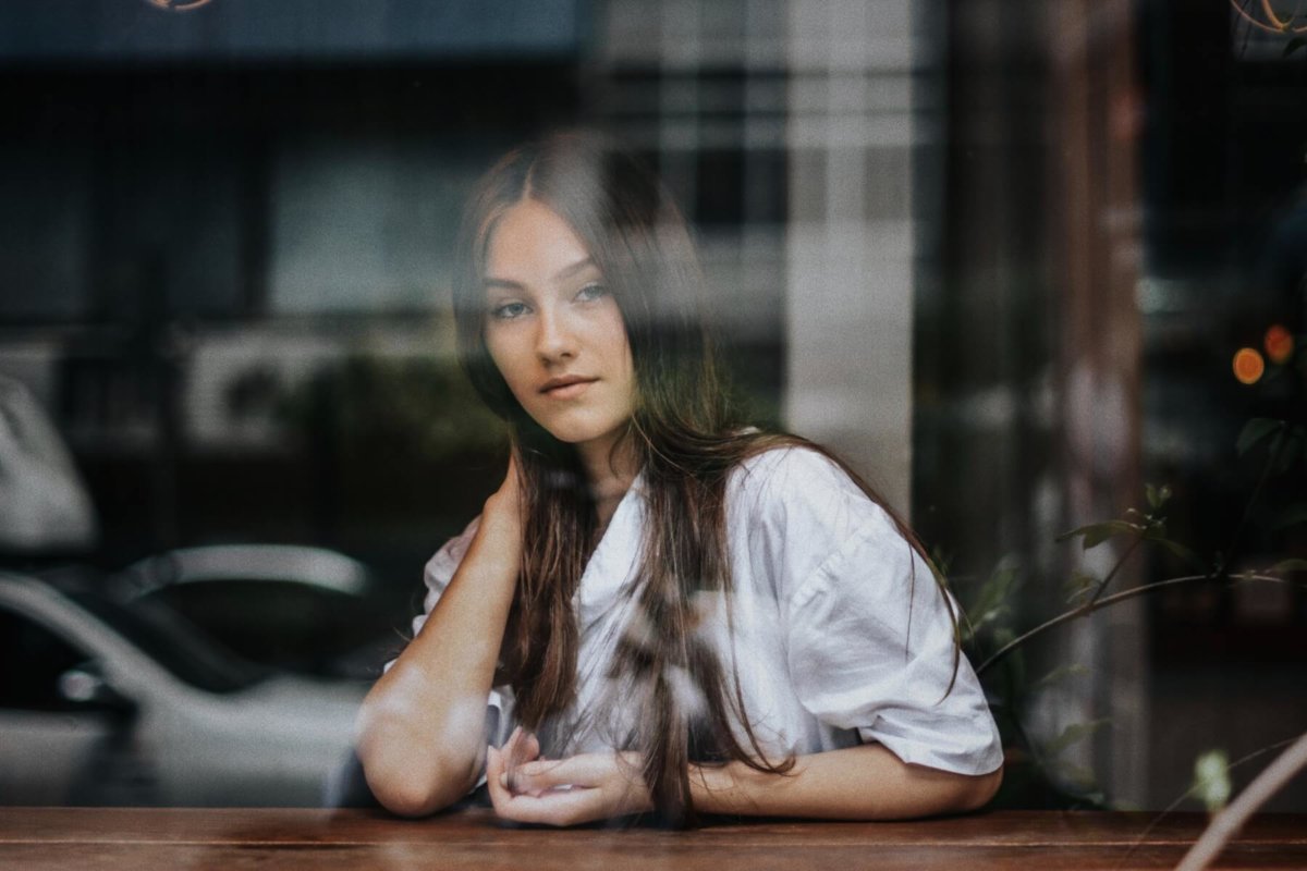 Woman looking out window. Photo credit: Joshua Rawson-Harris