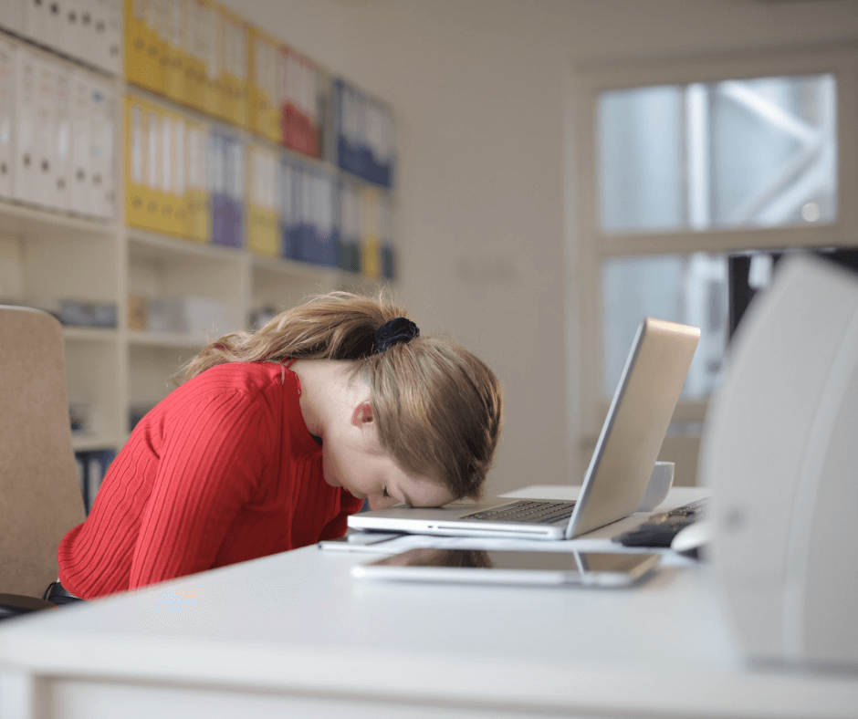 Woman asleep at computer in home office. Image credit: Andrea Piacquadio