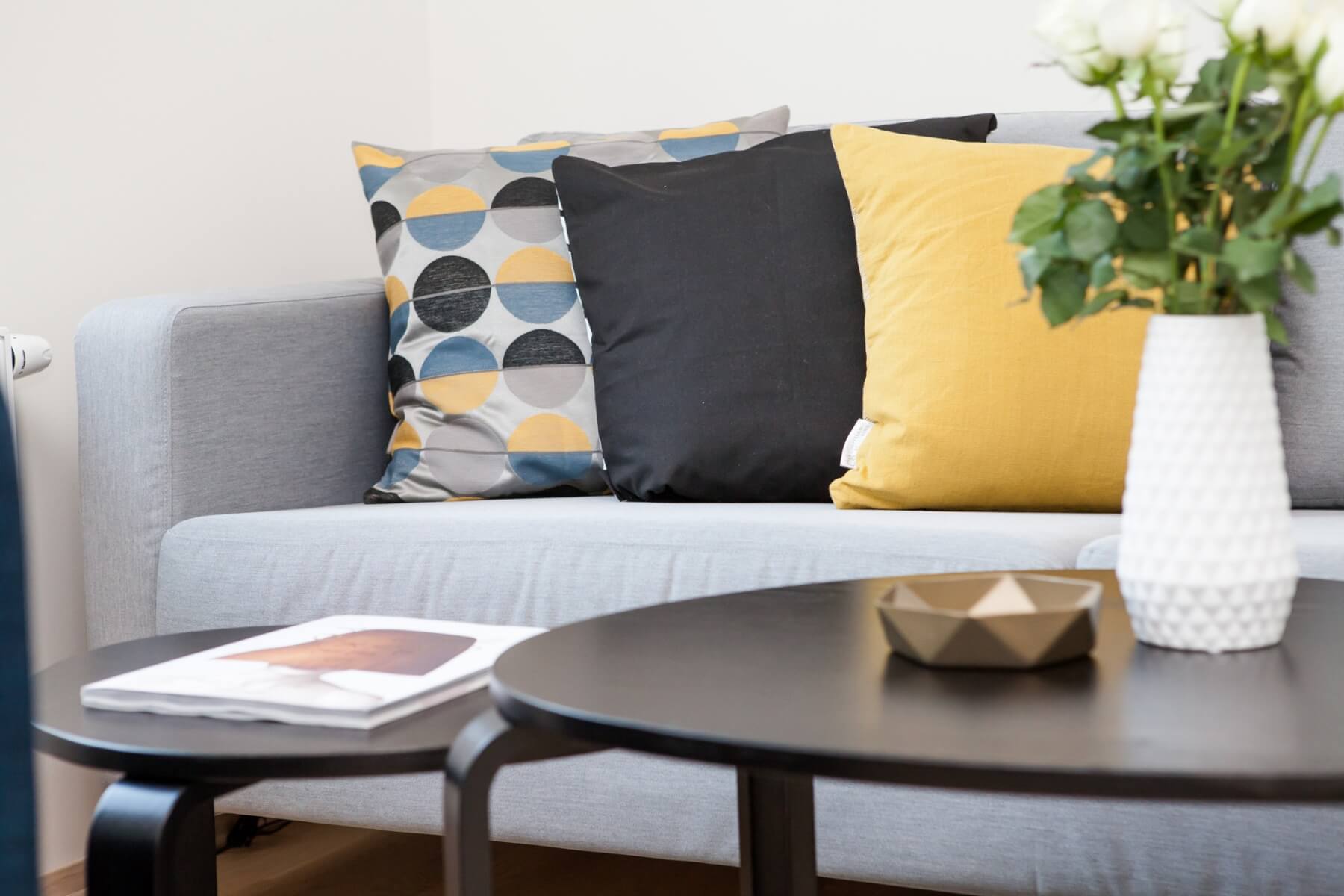 Colorful pillows on a living room couch. Photo credit: Terje Sollie