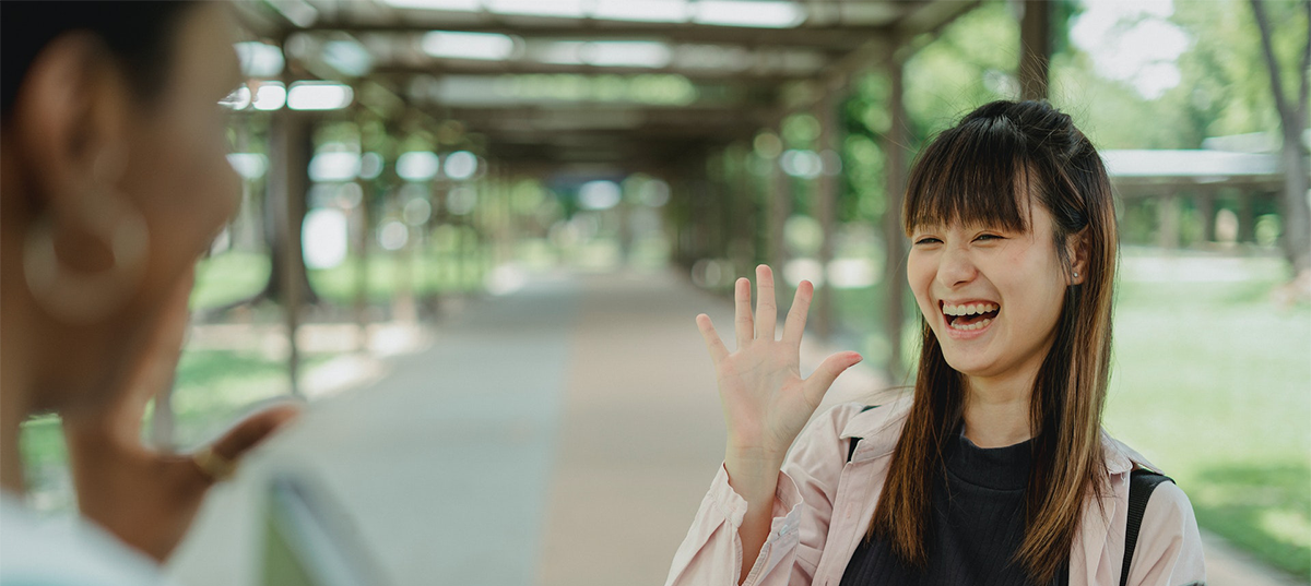 Young woman waving to a neighbor