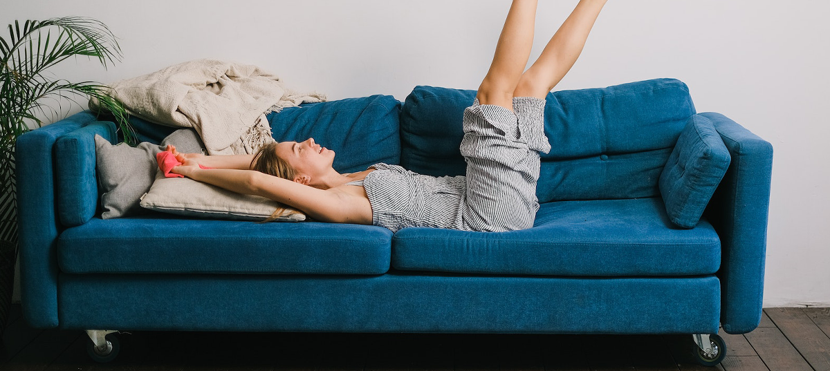 Woman on her couch smiling.