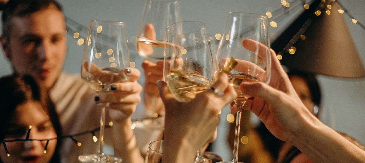 A group of people toasting with wine glasses. Image credit: Cottonbro.