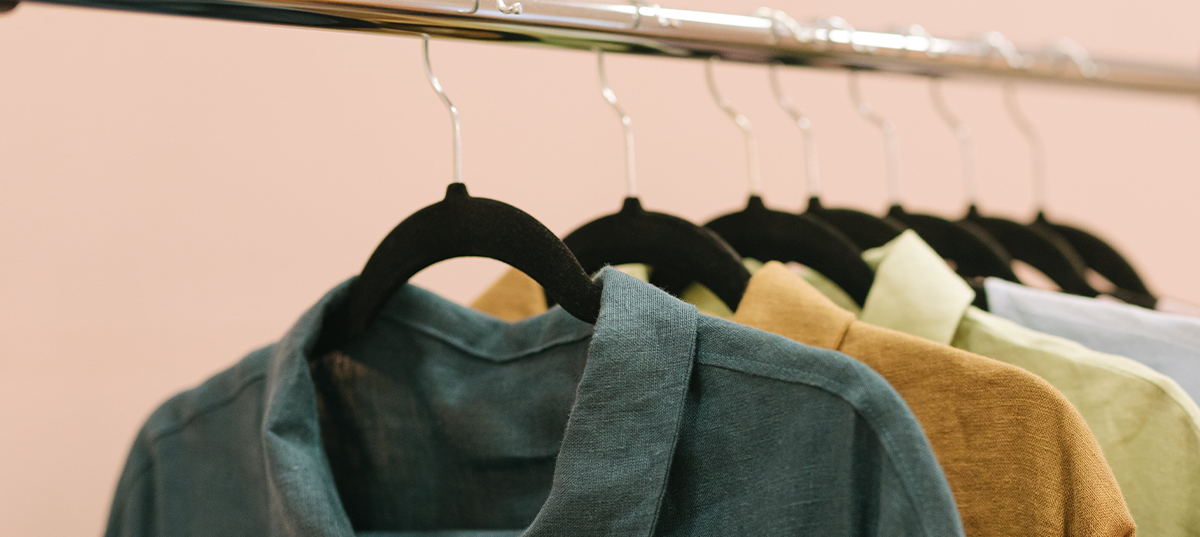 Thin shirts hanging on slim hangers in a closet. Image credit: Thirdman.