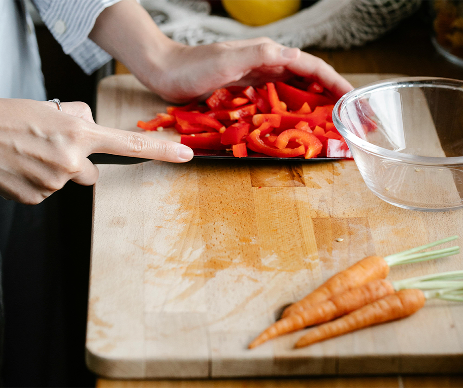Woman chopping vegetables on a cutting board