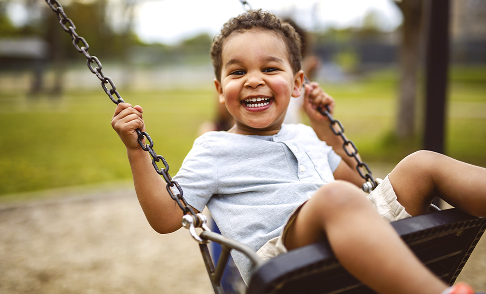 A young child at a nearby playground