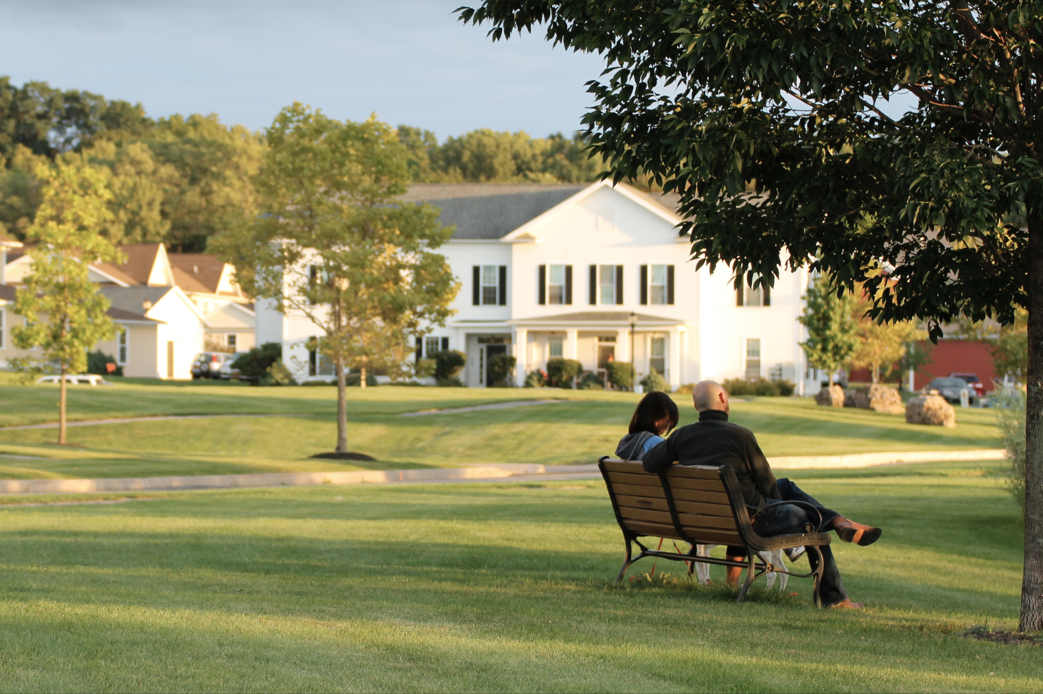 A couple sitting on a bench outside at Erie Station Village